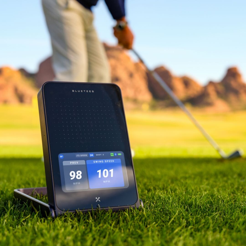 Blue Tees Rainmaker Launch Monitor outdoor practice with golfer swinging.