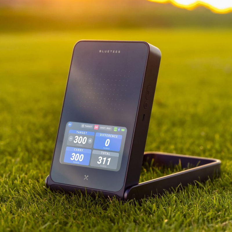 Blue Tees Rainmaker Launch Monitor outdoor sunset gameplay.