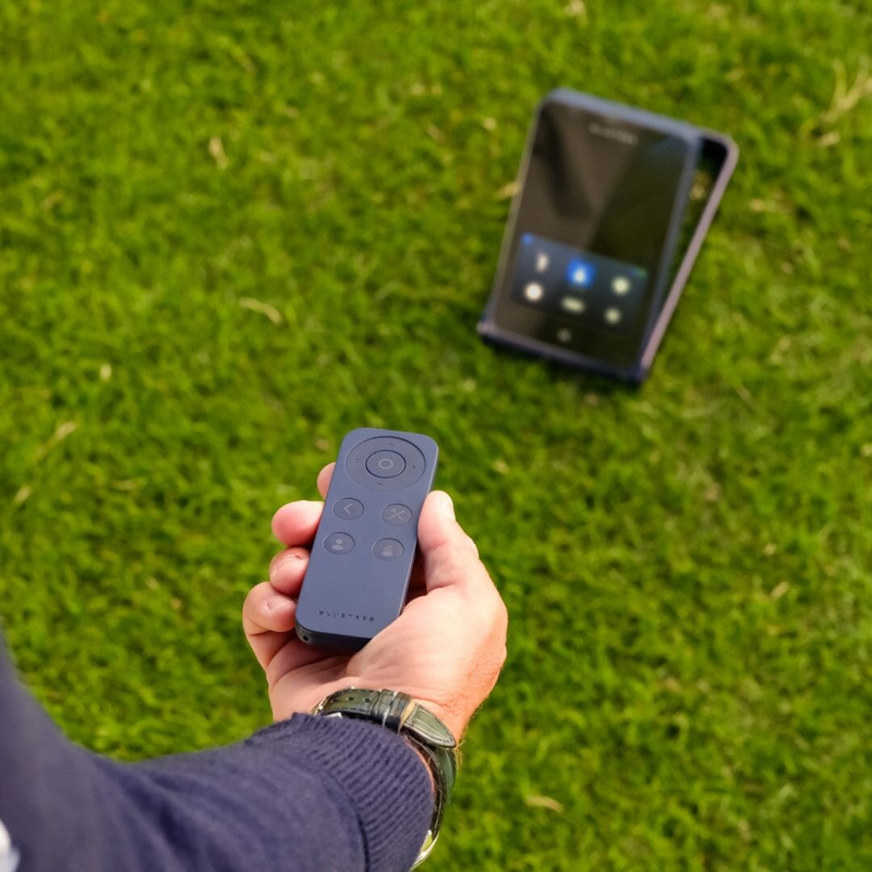 Blue Tees Rainmaker Launch Monitor remote control in hand.