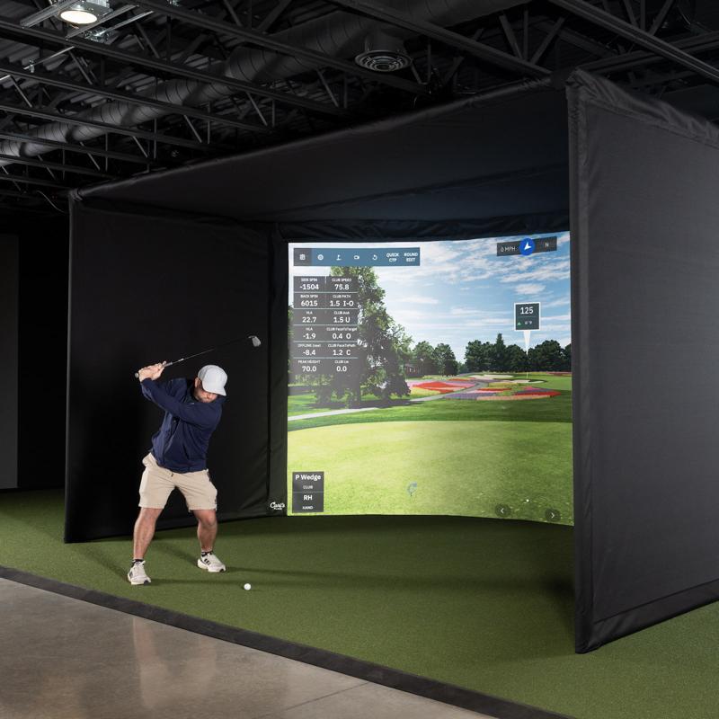 Carl's Place Curved Golf Simulator Enclosure included in the Uneekor EYE XO curved package, shown with a golfer swinging.