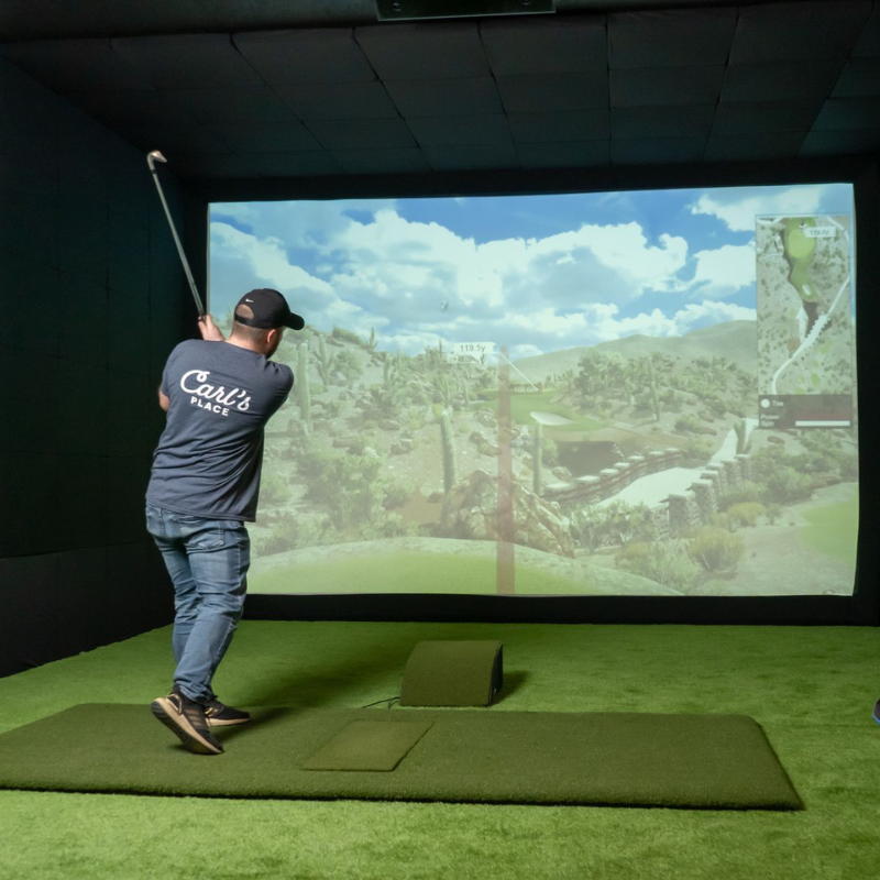 Carl's Place Floor Mounted Projector Enclosure with golfer swinging in simulator.