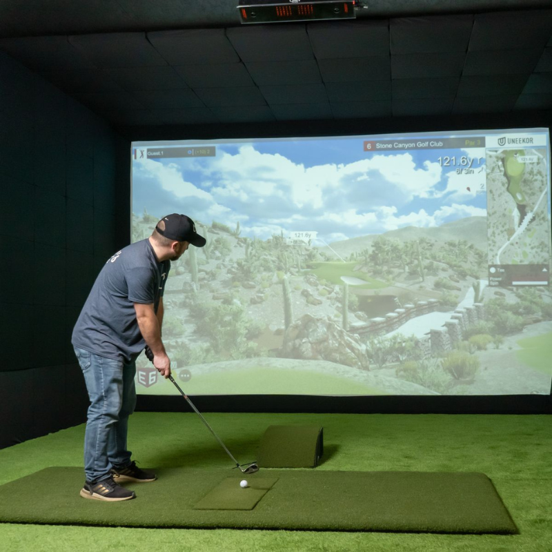 Carl's Place Floor Mounted Projector Enclosure with golfer in simulator.