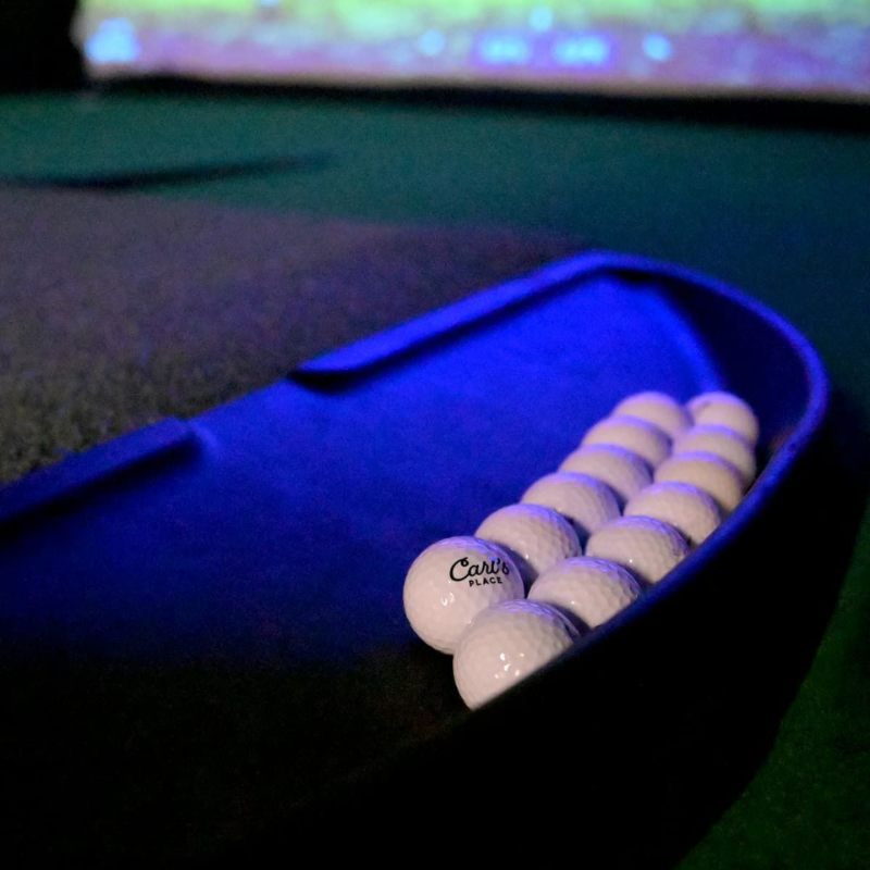 Carl's Place Golf Ball Tray aligned with golf mat.