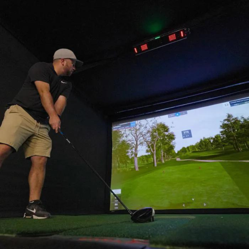 Carl's Place Uneekor EYE XO2 Protective Case installed in golf simulator with golfer setup.