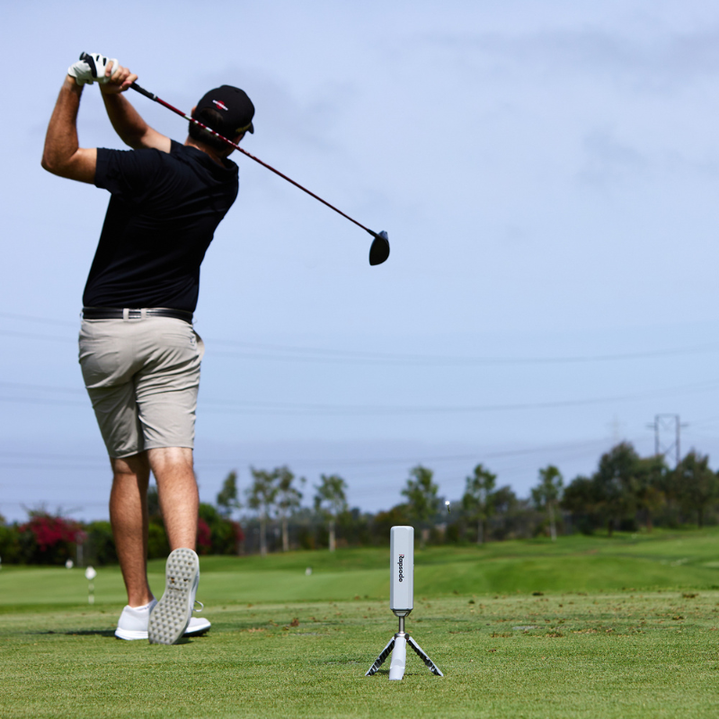 Rapsodo MLM2PRO on a driving range with golfer.