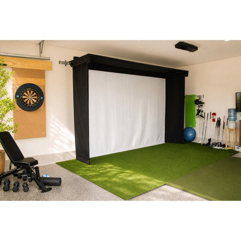 The SportsScreen Vanish LITE Series Golf Simulator Enclosure deployed in a bright garage gym.